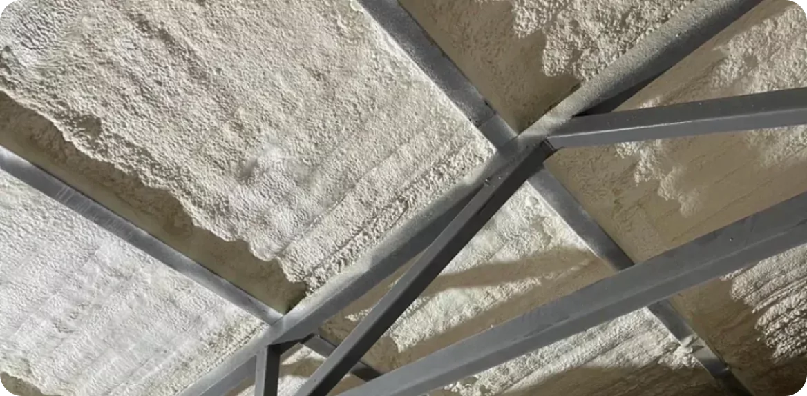 Spray polyurethane foam applied to a warehouse roof deck