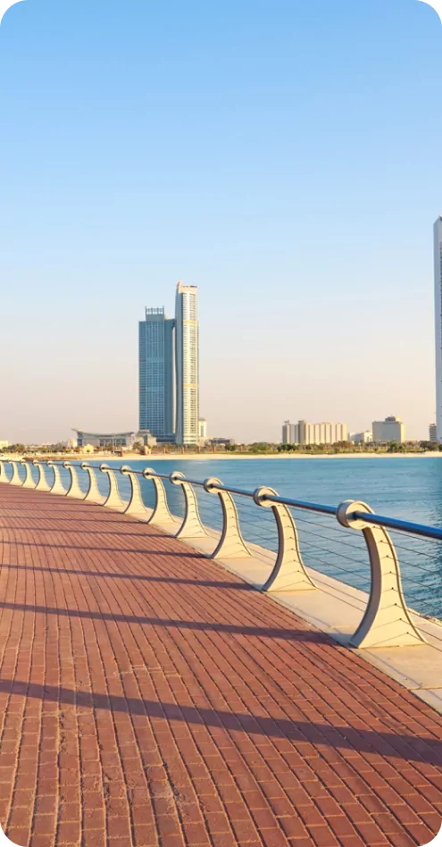 Waterfront promenade in the UAE under strong sunlight