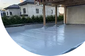 Coated below-grade slab beside a residential building