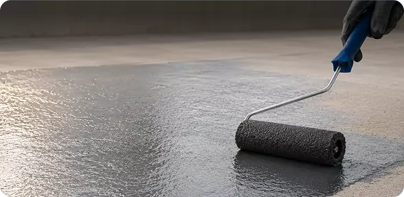 High-adhesion primer being roller-applied to a prepared substrate